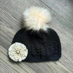 Hand crafted  black crochet girls hat with flower and fuzzy pom pom